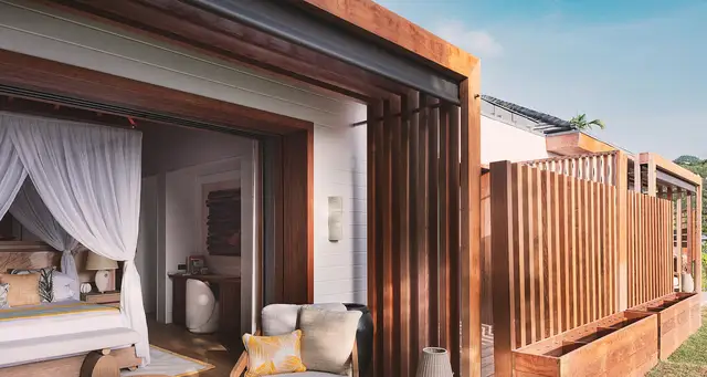 Covered outdoor area connecting to bedroom with canopy bed at Villa Nougat, Pointe Milou