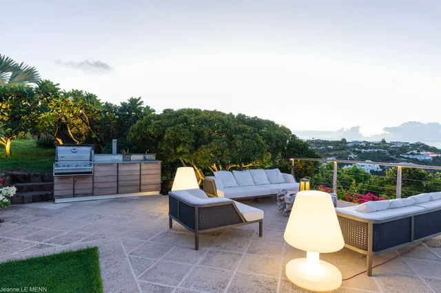Terrace with built-in grill and seating overlooking hillside at Villa Poppy, Mont Jean